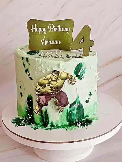 A Hulk themed cake for a 4th birthday. This no-fondant design has a cool green and white marbled effect, perfect for a little superhero fan.