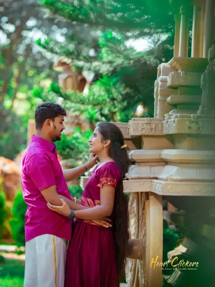 A sweet pre-wedding portrait in a garden setting. The soft light and natural surroundings highlight the couple's gentle affection.