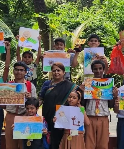 The winners of the art competition proudly display their artworks based on themes related to Gandhiji and India. Their talent was truly impressive.