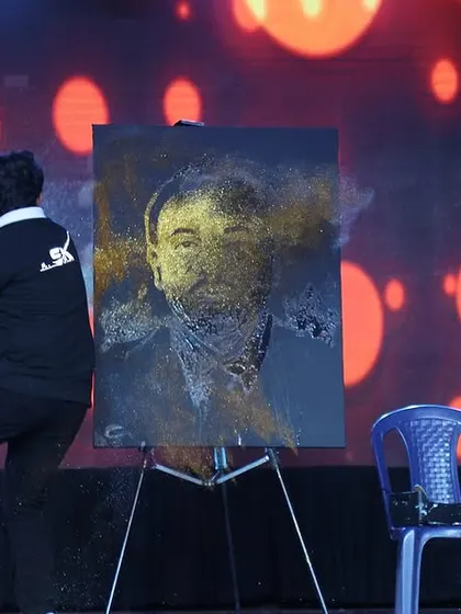 This action shot captures the most exciting part of my performance. The moment I throw the glitter onto the canvas is when the magic happens and the portrait comes to life.