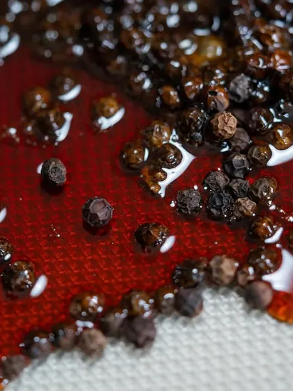 The vibrant color and texture of our black pepper caramel before it sets. We teach students how to work with sugar and create stunning visual effects.