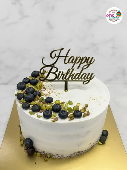 A rustic take on our blueberry cake, this design features a semi-naked finish and is decorated with fresh blueberries and crushed pistachios.