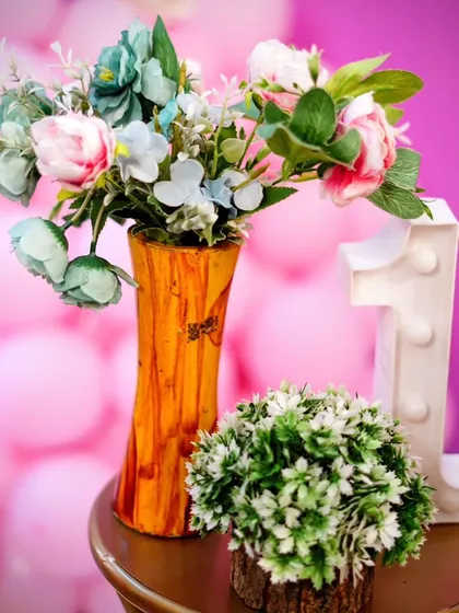 A close-up of a floral arrangement and a light-up number '1' prop.