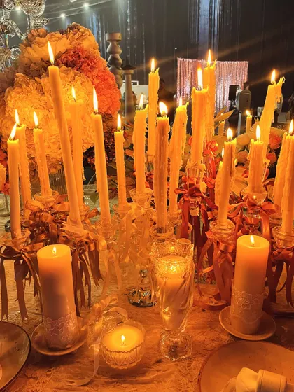 The tablescape illuminated by the warm, golden light of dozens of candles. This view captures the opulent and romantic atmosphere we created for the 'Lace Love' exhibition.
