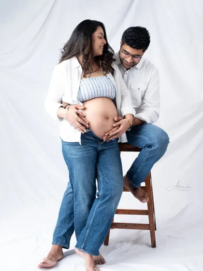 A relaxed and intimate moment. The couple shares a quiet look, creating a portrait that is both casual and full of love.
