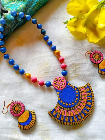 A fan-shaped pendant necklace in a beautiful blue and pink combination.
