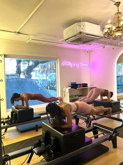 Planking together makes the burn better. This synchronized plank on the reformer box is a true test of core endurance and teamwork.