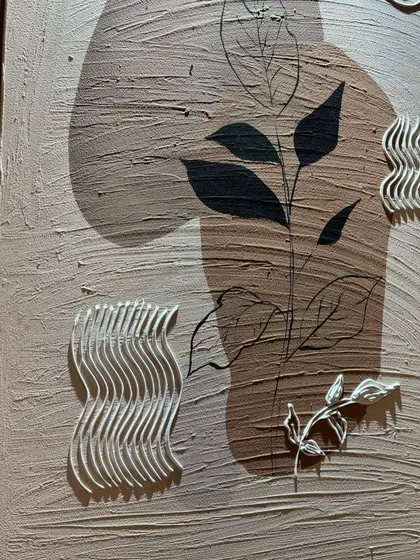 A detail shot of the botanical-themed arched panel, showing the delicate sculpted leaves and wavy patterns that add a tactile dimension to the artwork.