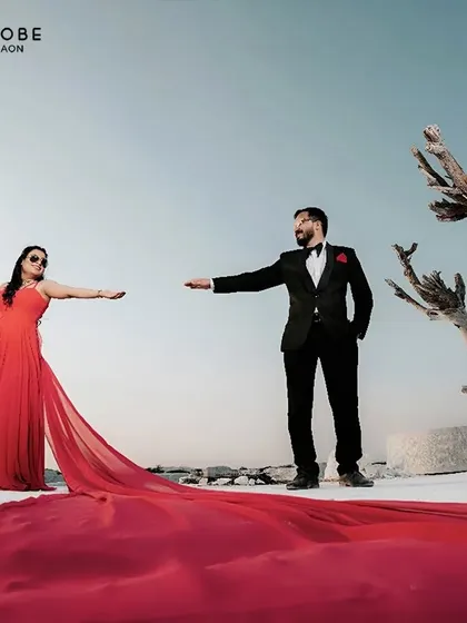 Your pre-wedding shoot deserves a showstopper. This fiery red trail gown creates a stunning contrast against a stark landscape, making for an unforgettable photo.
