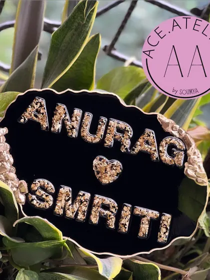 This black and gold nameplate for 'Anurag & Smriti' is bold and luxurious. The textured gold letters and geode edge make a strong statement.