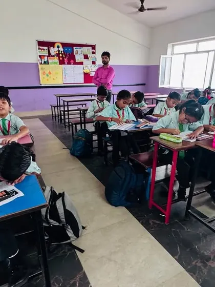 An instructor oversees a class at Sunshine Public School. We provide complete teacher training to ensure our high standards are met at every partner location.