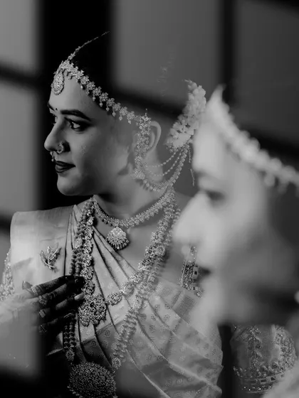An artistic black and white shot using reflection to create a layered and thoughtful bridal portrait.