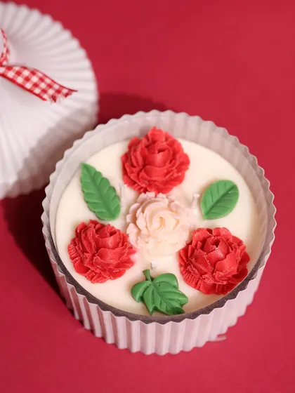 This beautiful cupcake-style candle with red floral details is another festive option I offer from my collaboration with Saanjh Shop.