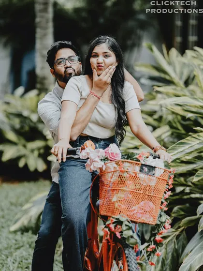 A playful and funny pose with a couple and a decorated bicycle, perfect for a lighthearted and casual pre-wedding shoot.