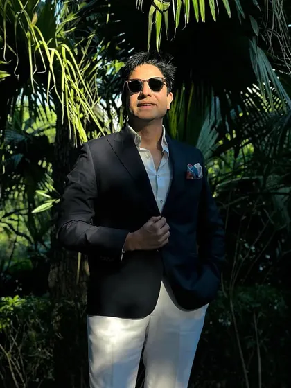 A cool, confident shot in the sunlight, surrounded by lush greenery. A great DJ is comfortable and stylish in any setting, day or night.