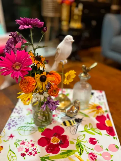 Another angle of our homegrown bouquet, featuring bright pink Gerbera daisies and marigolds. The vibrant colors bring so much life and happiness to this tabletop arrangement.