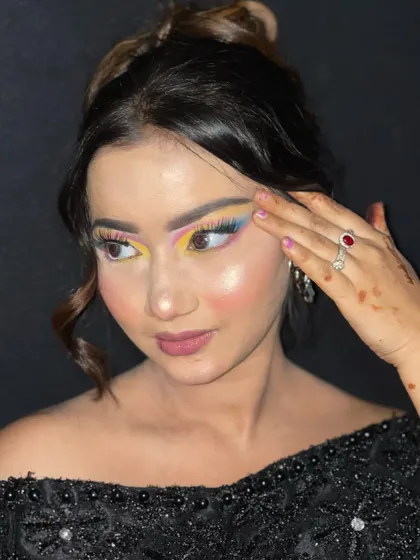 A side profile highlighting the sharp, colorful winged liner in this creative look.