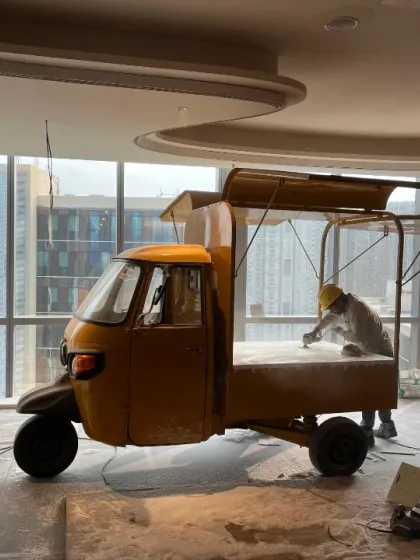 The project begins on site. Here, our team is prepping the auto-rickshaw inside the office space, getting the surface ready for the intricate hand painting and structural modifications to come.