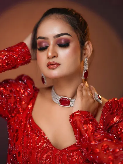 This pose highlights the ruby and diamond jewelry that completes the look.