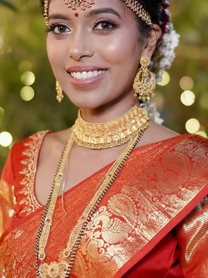 A radiant smile from my bride Preeti, wearing her red Kanjivaram wedding saree that I pre-pleated for her.