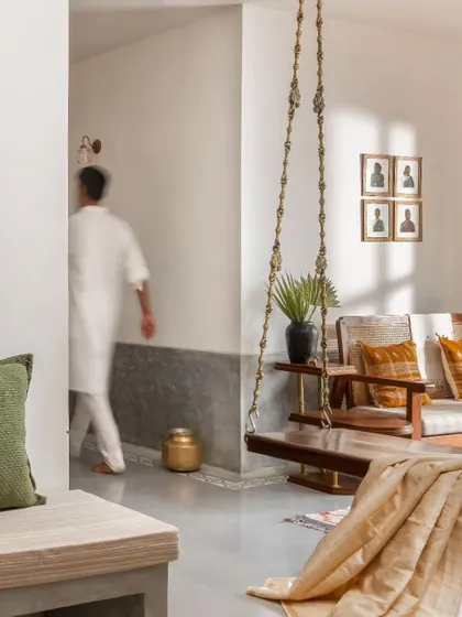 This view captures the dynamic quality of the living space, where modern open-plan design meets traditional elements like the indoor swing.