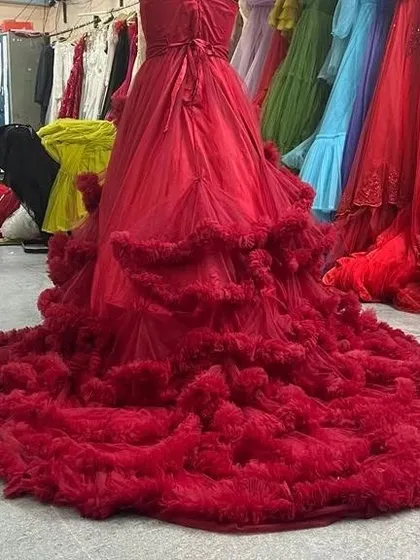 The back of a wine-red tube top gown, showing the rich texture of the heavily ruffled trail that follows behind you.