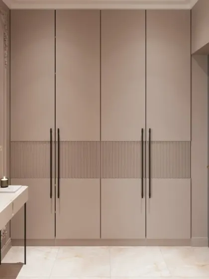 This minimalist wardrobe in a soft taupe color features a central textured panel for a subtle design accent. Paired with a simple console table, it creates a clean and elegant entryway or bedroom look.