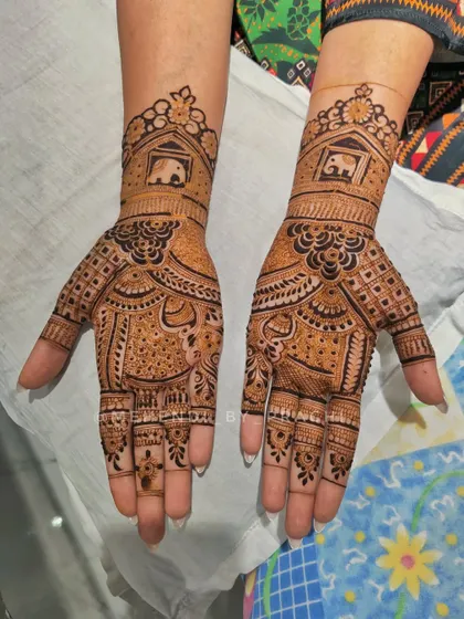 A beautiful Indian design for the bride's sister. It features small elephants in a window, a popular traditional motif, but in a lighter, non-bridal coverage.