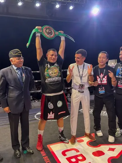The champion, his team, and the officials with the new belt.