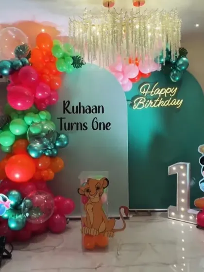 A jungle-themed decoration designed for a home celebration. This setup for Ruhaan's first birthday shows how we can bring big themes to smaller spaces, featuring characters from Winnie the Pooh and The Lion King.