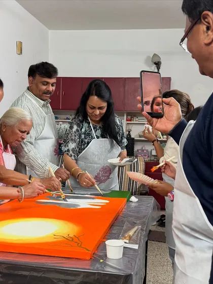 The whole family getting involved in painting a large collaborative canvas for a birthday celebration. It was a wholesome evening of laughter, colors, and love.