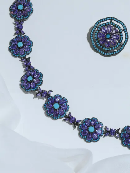 A detailed flat lay of the Amethyst and Turquoise necklace and one earring, emphasizing the contrast and harmony of the gemstones.
