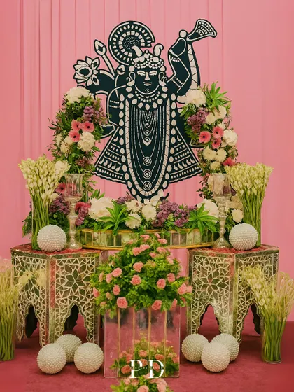 We incorporate personal and spiritual elements into our designs. This custom Shrinathji installation, framed by fresh flowers, served as a divine focal point for the wedding ceremony.