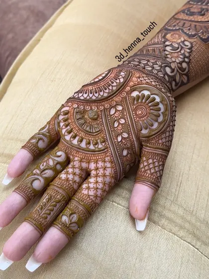 An elegant and dense design for the back of the hand. The intricate patterns and shading create a 3D effect, making the floral and paisley motifs stand out.