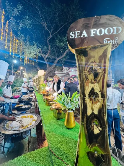 A long view of the seafood counter, bustling with chefs and guests.
