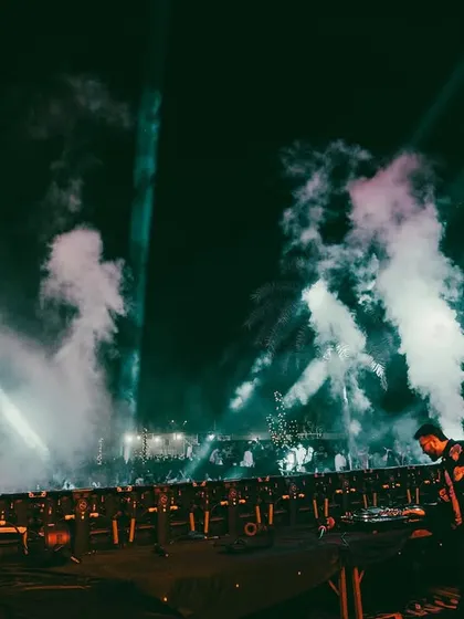 The stage enveloped in smoke and light, creating a dramatic and immersive experience for everyone.