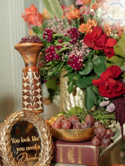 A fun and quirky decor piece at the bar that reads, "You look like you need a Drink!". Small, playful details like this add personality and humor to an event.