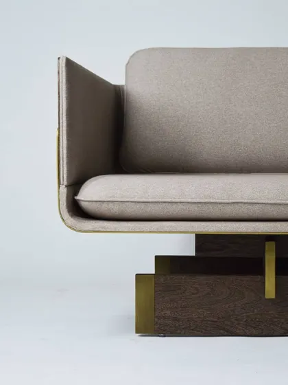 Detail of our TOKYO sofa, inspired by the linear and serene principles of Japanese architecture. The design features a sleek upholstered body resting on a base of Sucupira wood with antique bronze accents.