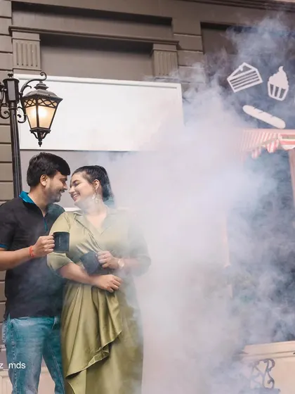 We use elements like smoke to add a touch of mystery and romance to our pre-wedding photos, as seen in this cafe-themed shot.