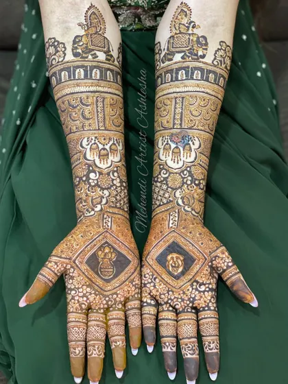 A complete bridal mehendi design featuring figures of a bride and groom on an elephant. The palms also have personalized symbols, making it a unique piece of art.