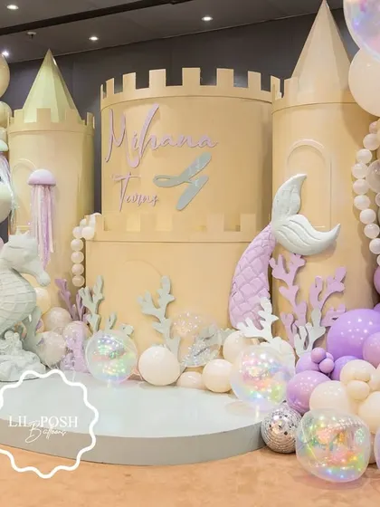 I designed an enchanting underwater kingdom for Mihana's mermaid-themed birthday. This magnificent castle backdrop, adorned with pastel balloon bubbles and iridescent details, was the centerpiece of a truly magical deep-sea adventure.