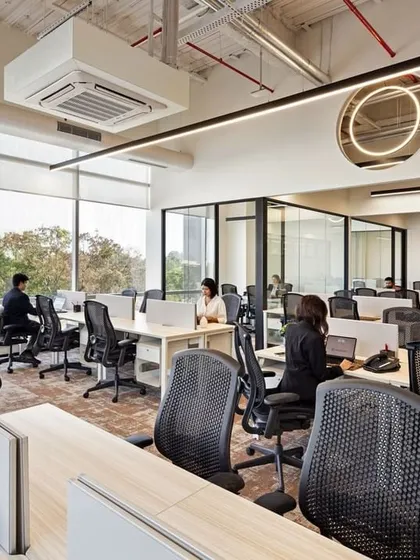 The open and bright workspace at CorporatEdge in Bangalore. Floor-to-ceiling windows flood the area with natural light, while the clean desk arrangement and glass-walled cabins promote a culture of transparency and collaboration.