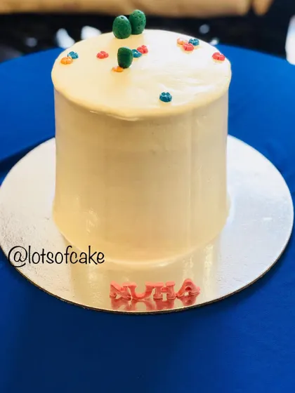 A simple and sweet red velvet cake, personalized with the name 'Nuha'. Even a simple design can be made special for a birthday celebration.