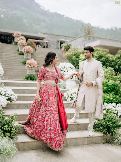 The couple making their way down a grand staircase lined with elegant floral arrangements. I design every part of the venue to create a cohesive and beautiful journey for you and your guests.