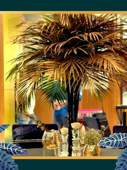 A golden palm tree centerpiece, another example of our custom props designed to fit a specific event theme.