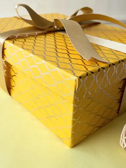 Our Diwali hamper comes in this beautiful and sturdy yellow box, tied with a golden ribbon.