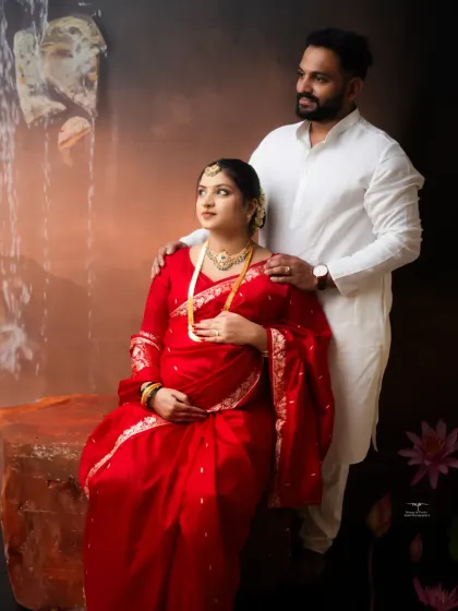 This portrait combines traditional elements with a touch of nature, featuring a gentle waterfall backdrop that adds a serene and unique feel to the couple's photo.