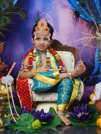 A majestic portrait from a 'Little Krishna' themed photoshoot. The elaborate costume, crown, and divine setup create a stunning image for Janmashtami or any special occasion.