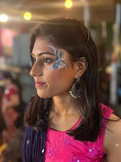 A blue floral design with silver glitter, adding a modern touch to a Navratri look.