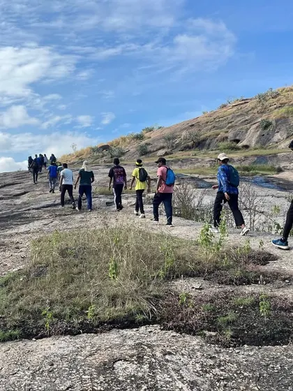 The approach to the climbing area often involves a scenic trek, warming up the group for the day.